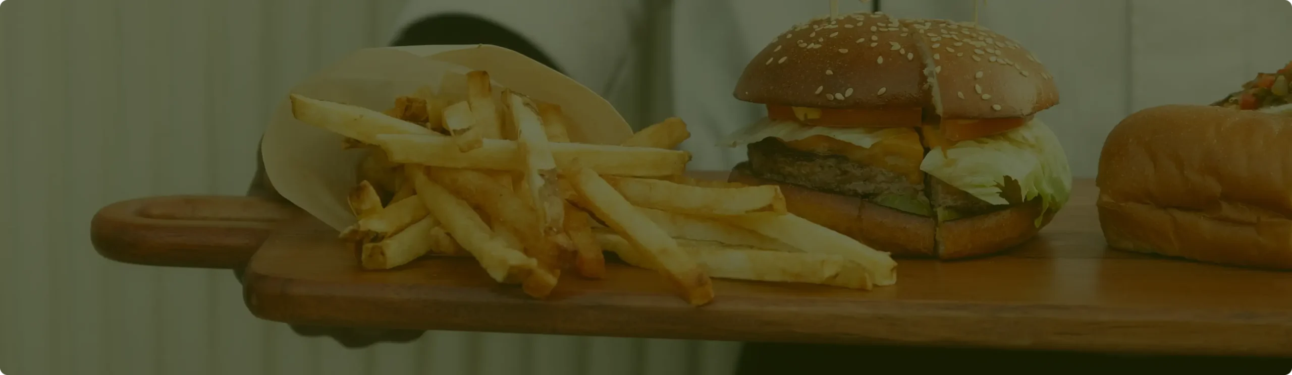 Burger and fries on wooden board