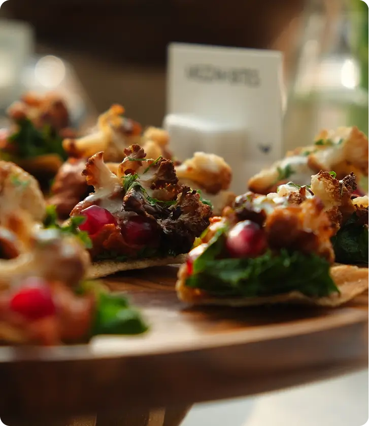 Gourmet appetizers served on wooden platter at restaurant